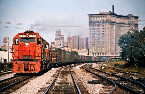 Westbound Detroit, Toledo and Ironton Railroad freight train on Conrail passing the Michigan Central Station in Detroit, Michigan, on September 5, 1976. Photograph by John F. Bjorklund, © 2016, Center for Railroad Photography and Art. Bjorklund-52-19-07