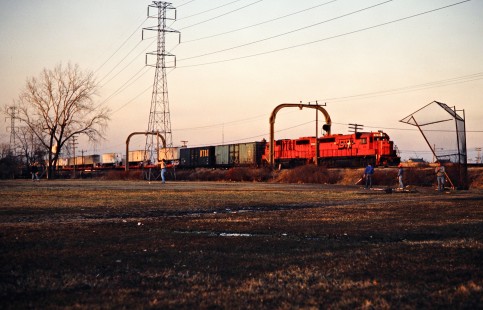 Southbound Detroit, Toledo and Ironton Railroad freight train passes a game of pickup baseball at Allen Park, Michigan, on April 14, 1982. Photograph by John F. Bjorklund, © 2016, Center for Railroad Photography and Art. Bjorklund-52-10-14