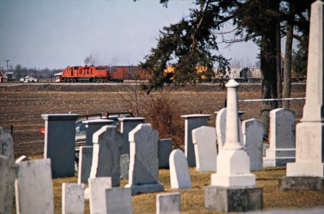 Southbound Detroit, Toledo and Ironton Railroad freight train passing Evergreen Cemetery in Flat Rock, Michigan, on March 10, 1974. Photograph by John F. Bjorklund, © 2016, Center for Railroad Photography and Art. Bjorklund-50-09-10