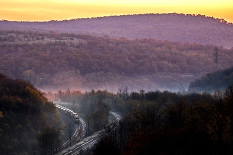 Westbound Norfolk Southern freight train approaching the summit of the Alleghenies at Gallitzin, Pennsylvania, on the morning of October 23, 2011. This the former Pennsylvania Railroad's main line; the famous Horseshoe Curve is just to the left. The photographer used Photoshop to make minor enhancements to color saturation, to lighten the shadows, and to increase contrast.