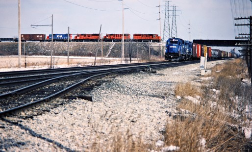Southbound Detroit, Toledo and Ironton Railroad and westbound Conrail freight trains in Delta, Ohio, on March 11, 1984. Photograph by John F. Bjorklund, © 2016, Center for Railroad Photography and Art. Bjorklund-52-17-13