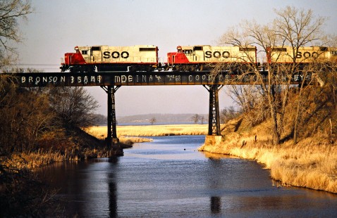 Westbound Soo Line Railroad freight train crossing bridge near Paynesville, Minnesota, on April 17, 1981. Photograph by John F. Bjorklund, © 2016, Center for Railroad Photography and Art. Bjorklund-83-17-06