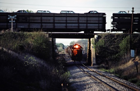 Eastbound Conrail and southbound Detroit, Toledo and Ironton Railroad freight trains in St. Paris, Ohio, on May 8, 1982. Photograph by John F. Bjorklund, © 2016, Center for Railroad Photography and Art. Bjorklund-52-12-07