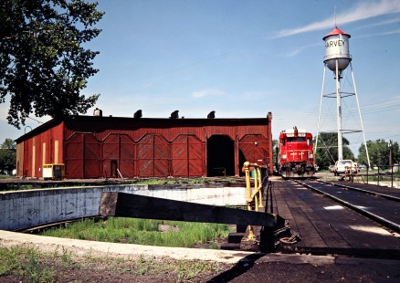 Soo Line Railroad roundhouse and GP30 locomotive no. 707 at Harvey, North Dakota, on July 5, 1980. Photograph by John F. Bjorklund, © 2016, Center for Railroad Photography and Art. Bjorklund-83-04-10
