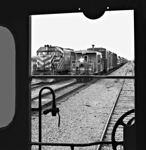 View from Katy caboose shows northbound Missouri Pacific Railroad freight train passing MKT local at Granger, Texas, in August 1972. Photograph by J. Parker Lamb, © 2016, Center for Railroad Photography and Art. Lamb-02-045-02