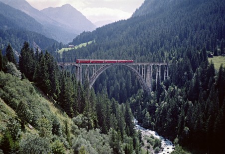 An electric passenger train of the one-meter-gauge Rhaetian Railway crossing Switzerland’s Langwieser Viaduct on August 29, 1998. Photograph by Fred M. Springer, © 2016, Center for Railroad Photography and Art. Springer-Swiss(1)-21-16