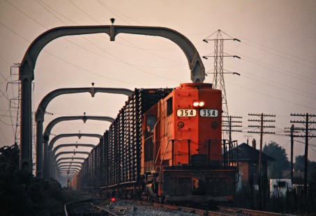 Southbound Detroit, Toledo and Ironton Railroad freight train at Penford Tower in Taylor, Michigan, on September 10, 1975. The overhead structures were part of an electrification project when Henry Ford owned the DT&I. Photograph by John F. Bjorklund, © 2016, Center for Railroad Photography and Art. Bjorklund-50-18-06