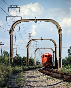 Southbound Detroit, Toledo and Ironton Railroad freight train in Taylor, Michigan, on August 7, 1981. The overhead towers were part of a short-lived electrification project from when Henry Ford owned the DT&I. Photograph by John F. Bjorklund, © 2016, Center for Railroad Photography and Art. Bjorklund-52-03-10