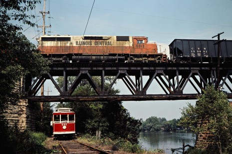 Westbound Illinois Central Gulf Railroad freight train cross the Fox River and an electric car of the R.E.L.I.C. Trolley Museum in South Elgin, Illinois, in September 1981. Photograph by John F. Bjorklund, © 2016, Center for Railroad Photography and Art. Bjorklund-60-17-03