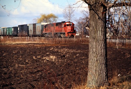 Detroit, Toledo and Ironton Railroad freight train in Scofield, Michigan, on April 3, 1977. Photograph by John F. Bjorklund, © 2016, Center for Railroad Photography and Art. Bjorklund-51-04-17