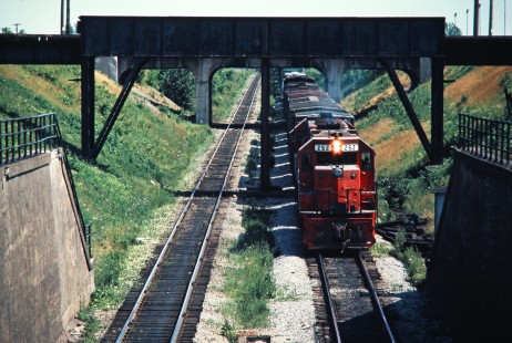 Westbound Detroit, Toledo and Ironton Railroad freight train on Conrail in Windsor, Ontario, on June 12, 1976. Photograph by John F. Bjorklund, © 2016, Center for Railroad Photography and Art. Bjorklund-50-27-16