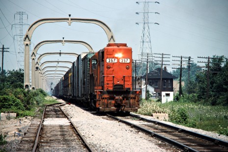 Southbound Detroit, Toledo and Ironton Railroad freight train at Penford Tower in Taylor, Michigan, on July 30, 1977. The overhead towers were part of a short-lived electrification project from when Henry Ford owned the DT&I. Photograph by John F. Bjorklund, © 2016, Center for Railroad Photography and Art. Bjorklund-51-07-11