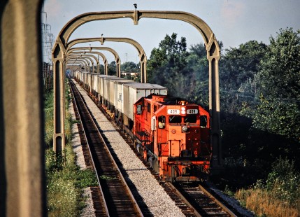 Southbound Detroit, Toledo and Ironton Railroad freight train  in Allen Park, Michigan, on August 11, 1981. The overhead towers were part of a short-lived electrification project from when Henry Ford owned the DT&I. Photograph by John F. Bjorklund, © 2016, Center for Railroad Photography and Art. Bjorklund-52-03-05