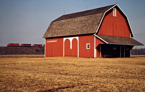 Southbound Detroit, Toledo and Ironton Railroad freight train passing a barn in Delta, Ohio, on March 15, 1980. Photograph by John F. Bjorklund, © 2016, Center for Railroad Photography and Art. Bjorklund-51-26-15