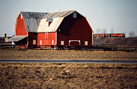Southbound Detroit, Toledo and Ironton Railroad freight train passing a barn in Delta, Ohio, on April 1, 1984. Photograph by John F. Bjorklund, © 2016, Center for Railroad Photography and Art. Bjorklund-52-18-10