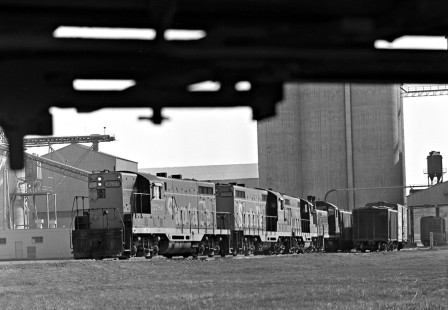 Atchison, Topeka and Santa Fe Railway local freight train pulls a cut of cars from plant, as viewed from train on main line between Cleburne, Texas, and Dallas in July 1978. Photograph by J. Parker Lamb, © 2016, Center for Railroad Photography and Art. Lamb-02-079-07