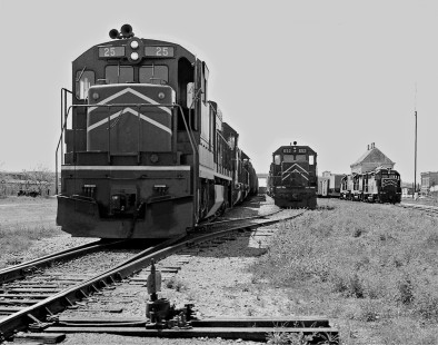 Northbound Missouri Pacific Railroad freight train departs Taylor, Texas, as two trains await departure in March 1975. Early MP U25C locomotives were forced into a two-digit number sequence. Photograph by J. Parker Lamb, © 2016, Center for Railroad Photography and Art. Lamb-02-064-08
