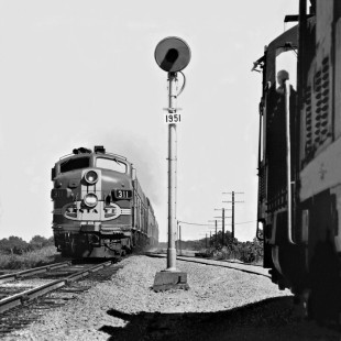 Northbound Atchison, Topeka and Santa Fe Railway <i>Texas Chief</i> passenger train speeds past local at Buckholtz, Texas (south of Temple), in June 1965. Photograph by J. Parker Lamb, © 2016, Center for Railroad Photography and Art. Lamb-02-066-08
