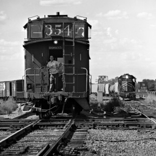 Northbound Atchison, Topeka and Santa Fe Railway local freight train pulls past Missouri Pacific Railroad crossing at Tower 55 in Fort Worth, Texas, as MP freight train approaches in August 1979. Photograph by J. Parker Lamb, © 2016, Center for Railroad Photography and Art. Lamb-02-069-11