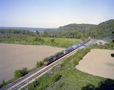 Milwaukee Road diesel locomotive no. 995 hauls westbound freight train no. 413 between Savanna and La Crosse. Image shot near Kemp, Iowa, on May 28, 1979. Photograph by Victor Hand.  Hand-MILW-C67-10