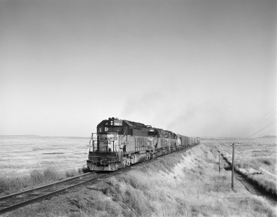 Milwaukee Road diesel locomotive no. 18 leads westbound freight train no. 201 near Carlmar, Washington, on September 13, 1979. Photograph by Victor Hand. Hand-MILW-67-157