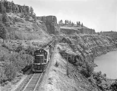 Milwaukee Road diesel locomotive no. 186 leads eastbound freight train no. 200 through Tunnel 44 at the edge of Rock Lake,  in Washington on June 18, 1968; Photograph by Victor Hand. Hand-MILW-67-086