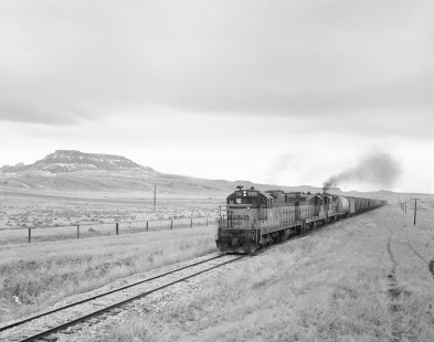 Milwaukee Road diesel locomotive no. 556 hauls freight east from Great Falls on February 26, 1980. Image shot on February 26, 1980 near Square Butte, Montana. Photograph by Victor Hand. Hand-MILW-67-181
