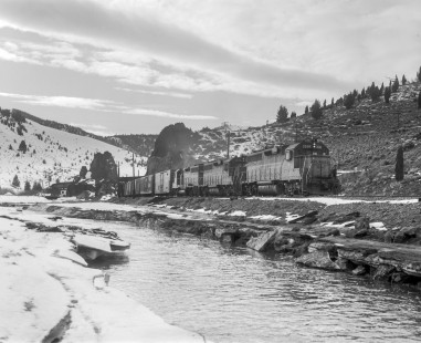 Milwaukee Road diesel locomotive no. 2026, hauls eastbound freight near Grace, Montana, on February 25, 1980. Photograph by Victor Hand. Hand-MILW-67-179
