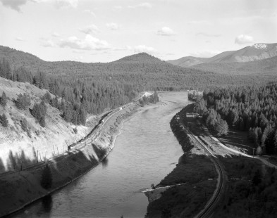 A Milwaukee Road freight train travels westbound along the Saint Regis River near Saint Regis, Montana, on May 16, 1974. Photograph by Victor Hand; Hand-MILW-67-044
