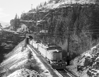 Milwaukee Road electric locomotives nos. E20 and E79 lead eastbound freight through tunnel near Alberton, Montana on December, 4, 1972. Photograph by Victor Hand. Hand-MILW-67-011.JPG.