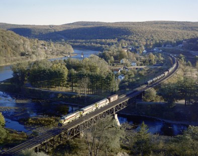 Erie Lackawanna Railroad diesel locomotive no. 2507 leads freight train over truss bridge spanning the Lackawaxen River in Lackawaxen, Pennsylvania, on October 11, 1964; Photograph by Victor Hand. Hand-EL-C30-002