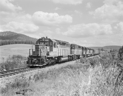 Milwaukee Road diesel locomotive no. 135 hauls westbound grain near Mowry, Idaho, on June 17, 1968. Photograph by Victor Hand. Hand-MILW-67-075