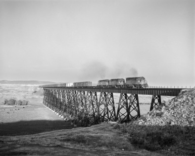 Milwaukee Road diesel locomotive no. 18 leads westbound freight train no. 201 across trestle bridge near Hillcrest, Washington, on September 13, 1979. Photograph by Victor Hand.  Hand-MILW-67-159