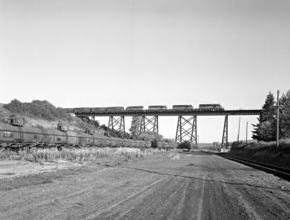 Milwaukee Road diesel locomotive no. 201 leads eastbound freight across a trestle bridge near Tekoa, Washington on June 18, 1978. Photograph by Victor Hand. Hand-MILW-67-080