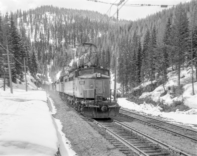 Milwaukee Road electric locomotive no. E77 leads eastbound freight train no. 264 near Portal, Montana on May 16, 1974. Photograph by Victor Hand. Hand-MILW-67-033