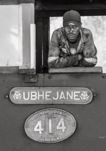 Boiler attendant Thanisani Ngwenya stares down the camera from the window of Garratt locomotive #414 while stopped at Hwange station, Zimbabwe, on July 9, 2017. 

Read more about the <a href="http://www.railphoto-art.org/awards/2019-awards/" rel="noreferrer nofollow">2019 John E. Gruber Creative Photography Awards Program</a>.