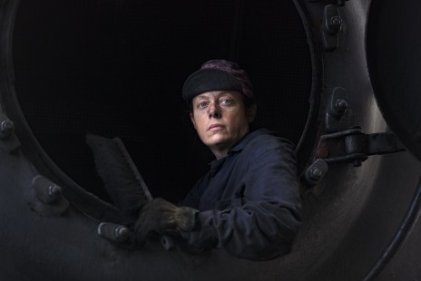 We Can Do It, Shelley Hall peers out of the boiler of Strasburg Rail Road no. 90 after cleaning the locomotive. Strasburg, Pennsylvania, November 6, 2017. 

Read more about the <a href="http://www.railphoto-art.org/awards/2019-awards/" rel="noreferrer nofollow">2019 John E. Gruber Creative Photography Awards Program</a>.