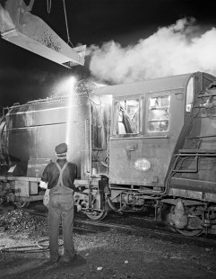 New Zealand Government Railways employee washes steam locomotive no. 1232 in Greymouth on the South Island of New Zealand on June 9, 1967. Photograph by Victor Hand. Hand-NZGR-12-0990.