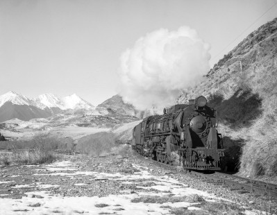New Zealand Government Railways steam locomotive no. 966 hauls westbound freight train between Springfield and Arthur's Pass on July 25, 1966. Photograph shot near Mount White. Photograph by Victor Hand. Hand-NZGR-10-844.JPG.