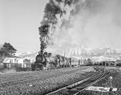 Fireman John Trim is visible in the cab of New Zealand Government Railway steam locomotive no. 616 hauls eastbound freight between Springfield and Christchurch on the South Island of New Zealand on July 21, 1966. Photograph by Victor Hand. Hand-NZGR-10-752