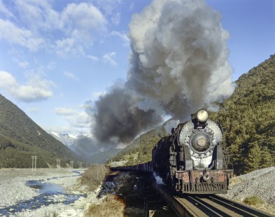 New Zealand Government Railways steam locomotive no. 967 hauls freight between Springfield and Arthur's Pass on June 14, 1967. Photograph shot at Arthur's Pass in the Southern Alps of New Zealand's South Island. Photograph by Victor Hand. Hand-NZGR-C12-72