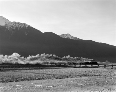 New Zealand Government Railways steam locomotive no. 969 leads a freight train over the Waimakariri River in inland Canterbury, near Arthur's Pass, on the South Island of New Zealand on June 16, 1967. Photograph by Victor Hand. Hand-NZGR-12-1132