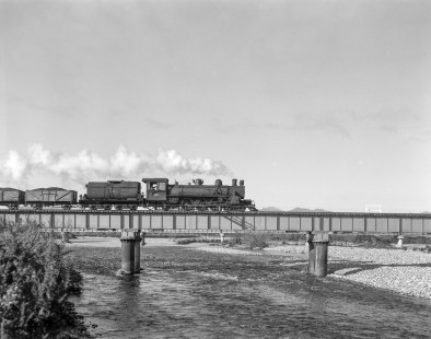 New Zealand Government Railways steam locomotive no. 755 hauls freight between Westport and Greymouth on the South Island of New Zealand on June 10, 1967. Photograph taken near Ikamatua. Photograph by Victor Hand. Hand-NZGR-12-1015.