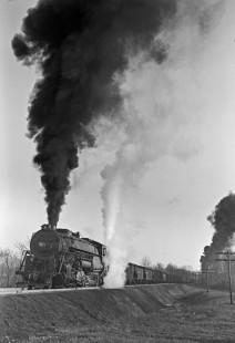 Lehigh and New England 2-10-0 steam locomotive 403 pulls twenty-six cars of freight train east at Summit, Pennsylvania, with 2-8-0 locomotive 304 pushing on March 16, 1946. Note the white steam from the 403's booster engine on the tender. Photograph by Donald W. Furler, Furler-02-061-02, © 2017, Center for Railroad Photography and Art