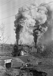 Lehigh and New England steam locomotives 307 and 401 storm east out of Bath, Pennsylvania, with twenty-three cars on the steep grade to Summit on March 10, 1946. They are "doubling the hill" with the first half of a forty-seven car train. Photograph by Donald W. Furler, Furler-02-054-02, © 2017, Center for Railroad Photography and Art
