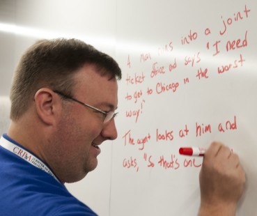 Brian Schmidt, of Trains and Classic Trains magazines, adds a train joke to the white board during a break on Sunday morning. CRP&A Conversations 2019 photograph by Henry A. Koshollek