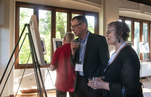 Marc Hilton and Linda Schafer view the photography exhibition by Eric Williams at the Friday reception. CRP&A Conversations 2019 photograph by Henry A. Koshollek