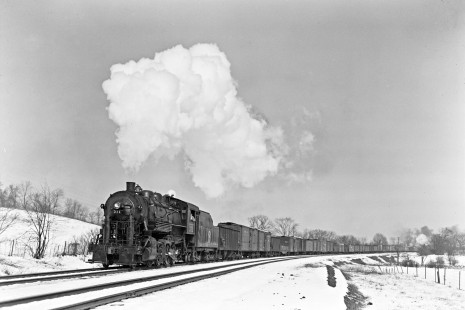 New York, Ontario and Western 2-8-0 steam locomotive 311 leading westbound freight with 41 cars and locomotive 227 pushing at Maybrook, New York, on February 23, 1946. Photograph by Donald W. Furler, Furler-13-012-02, © 2017, Center for Railroad Photography and Art