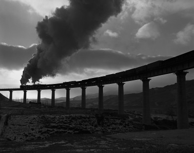 Two Jitong Railway QJ-class steam locomotives lead eastbound freight train over the Simingyi Viaduct, west of Hadashan, Inner Mongonlia, China on November 20, 2002. Photograph by William Botkin. © 2002, William Botkin