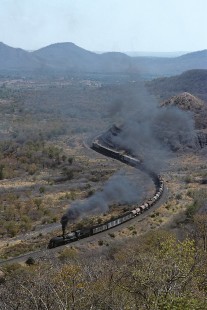 National Railways of Zimbabwe 15th-class Garratt steam locomotive hauls southbound freight north of Wankie (present-day Hwange) in Matabel, Zimbabwe, on July 4, 1992. Photograph by Katherine Botkin. BOTKINK-114-KT-75, © 1992, Katherine Botkin.